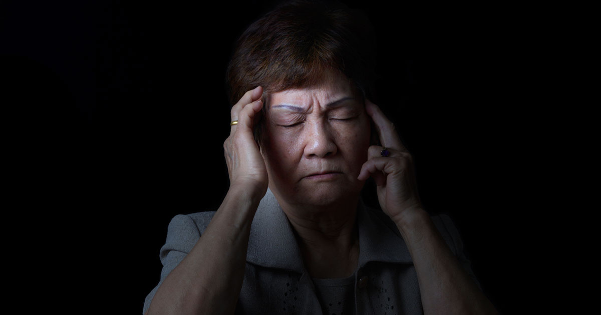 A woman is experiencing a headache