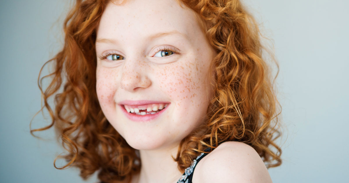 Red haired girl with a few teeth missing