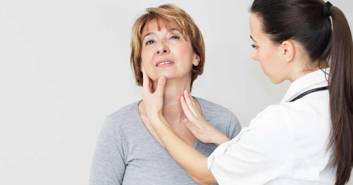 A doctor is physically examining a patient's thyroid