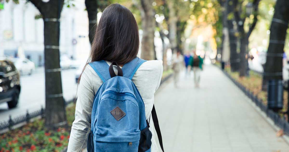 Woman with a backpack on a college campus